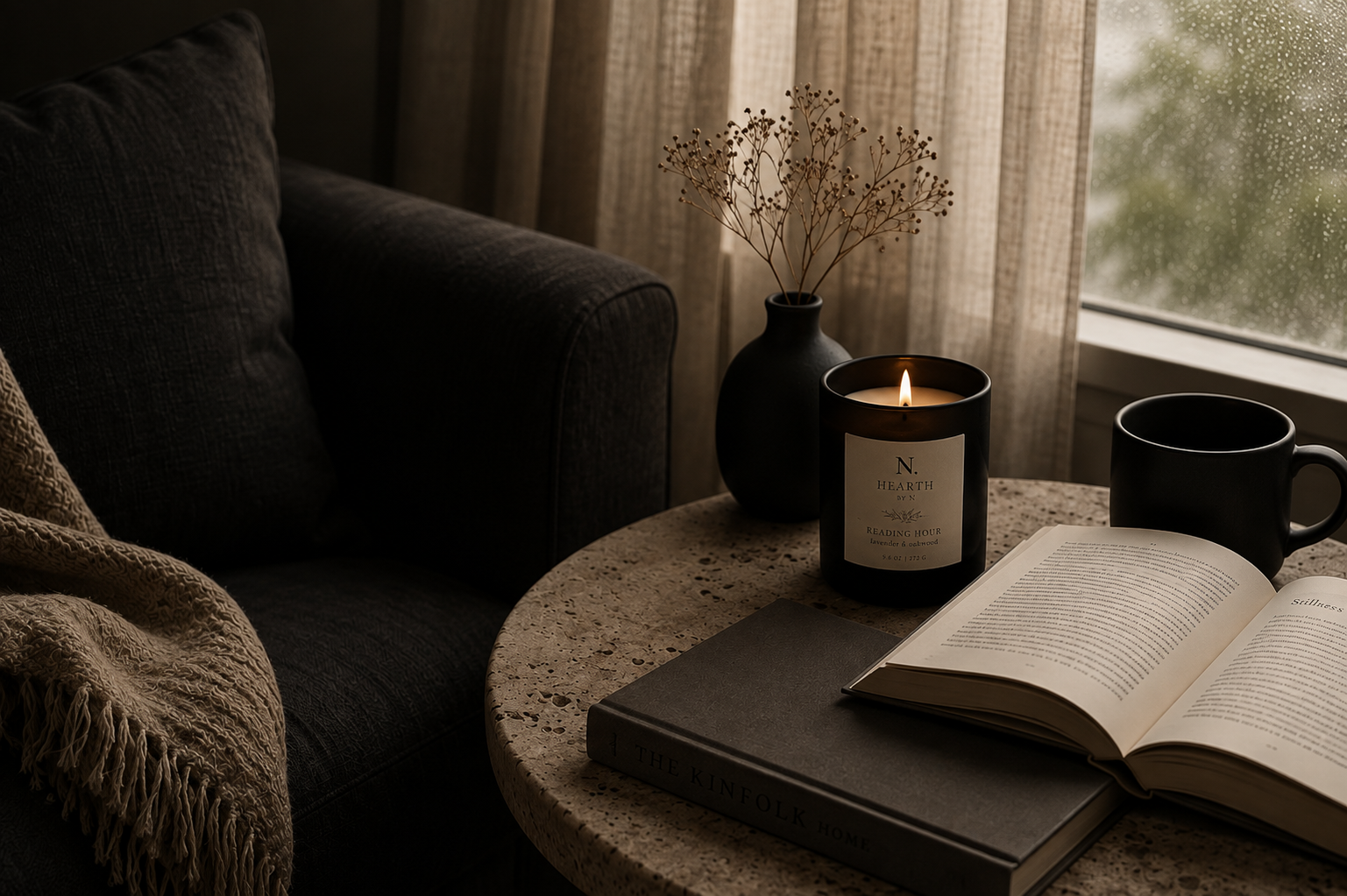 A quiet reading corner at home, lit by a HEARTH by N candle